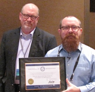 Ryan Mattke accepting award from Dan Ross